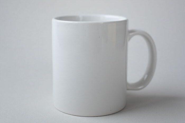Simple white ceramic mug with a clean, minimalist design against a plain background.