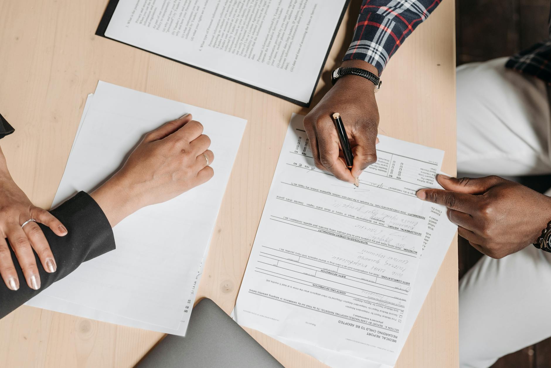 people doing paperwork at a desk